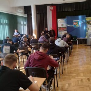 uczniowie w ławkach wypełniają test