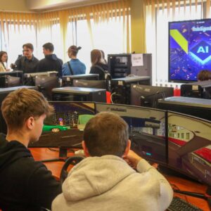 wnętrze sali komputerowej, przy stanowiskach siedzą uczniowie