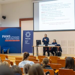 Przedstawicielki Wydziału Prewencji Komendy Miejskiej Policji w Przemyślu na scenie w uczelnianej auli